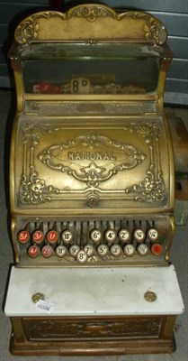 Lot 284 - A National Cash Register, with embossed brass fascia, draw and pediment, marble slab above...