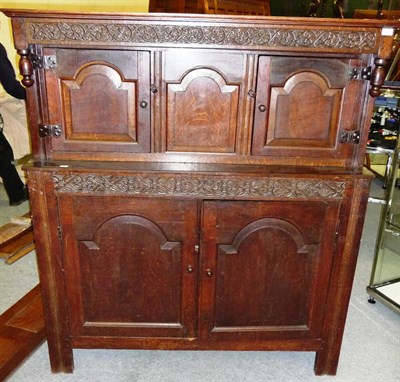 Lot 1403 - An Early 18th Century Joined Oak Court Cupboard, the moulded cornice above a scrolling leaf...