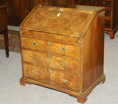 Lot 1408 - A George II Walnut Bureau, the slope enclosing a fitted interior with well, over three long...