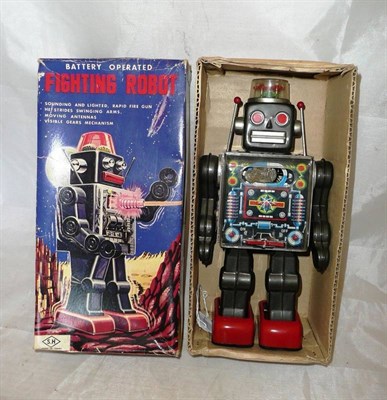 Lot 103 - A Boxed Japanese Battery Operated Tinplate Fighting Robot by Horikawa, with grey body, red...