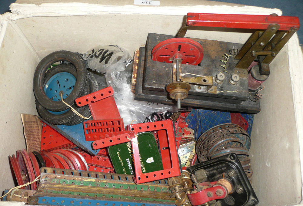 Lot 119 - A Small Collection of Meccano, parts in red, blue, green, gold and yellow, also cogs, wheels,...