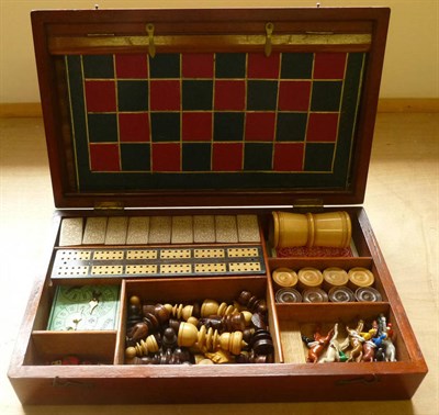 Lot 167 - A Mahogany Cased Games Compendium, containing dominoes, chess set, draughts, cribbage board, cards