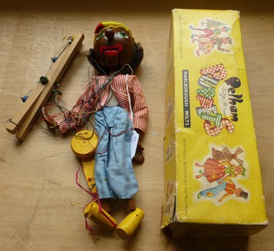 Lot 189 - A Boxed Pelham Puppet of a Minstrel, the brown painted wooden head with articulated mouth, red...