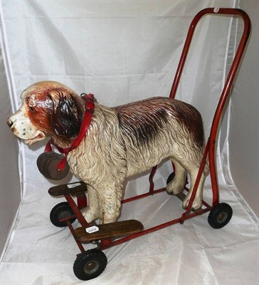 Lot 195 - A St Bernard Dog Push Along Toy, the rubber dog with wooden barrel around neck, on a tubular...