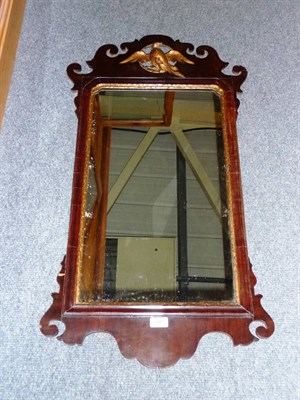 Lot 1427 - A George III Mahogany and Parcel Gilt Mirror, the rectangular plate within a leaf moulded slip, the