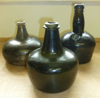 Lot 280 - Two Early Hand Blown Onion Shaped Green Glass Wine Bottles, one straight sided, the other of...