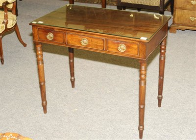 Lot 1444 - A George IV Mahogany Side Table, the rectangular top above three frieze drawers, raised on ring...