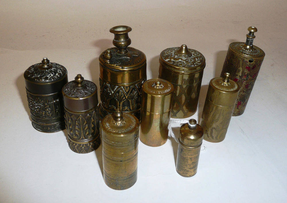 Lot 301 - Nine Brass 'Go-To-Bed' Vesta Boxes, including one with candlesticks 'By Royal Letters Patent',...