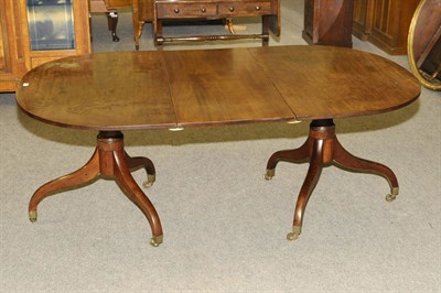 Lot 1470 - A Late George III Mahogany Twin Pedestal Dining Table, the rounded rectangular top raised on...