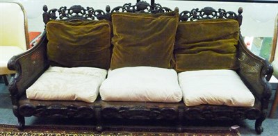 Lot 1475 - An Early 20th Century Walnut Framed Bergere Suite, comprising three-seater settee and two...