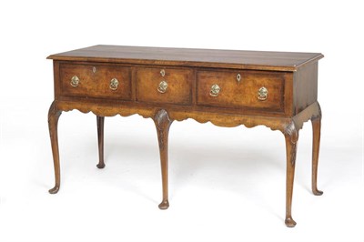 Lot 1477 - A George II Style Walnut Low Dresser, 20th century, the rectangular crossbanded top above three...