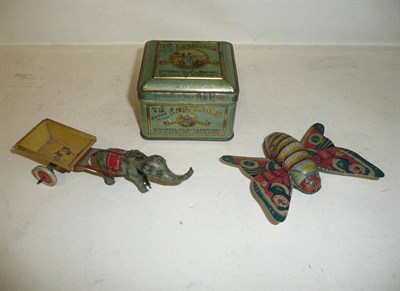 Lot 110 - A Tinplate Elephant with Cart Penny Toy, a tinplate friction drive butterfly and a 'Te...