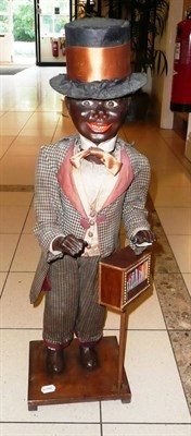 Lot 165 - A German  Automaton Negro Minstrel, with card body, composition feet, moving hands and nodding head