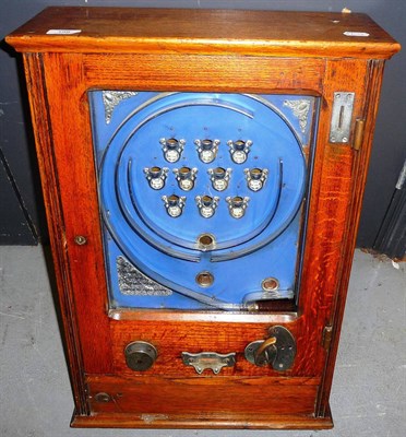 Lot 189 - An Oak Cased Wall Mounted Allwins Type Flick a Ball Coin Operated Amusement Machine, with blue...