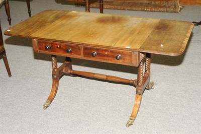 Lot 1494 - A Regency Mahogany and Crossbanded Sofa Table, the rectangular top with two conforming drop...