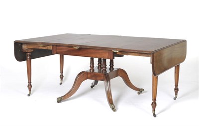 Lot 1499 - A Regency Mahogany Extending Dining Table, the rectangular top with two hinged drop leaves,...