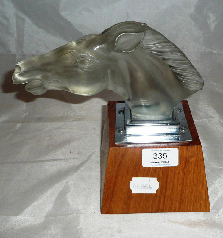 Lot 335 - A Lalique Style Glass Horse Head Car Mascot, with chrome mount, on a wooden base, length 20cm