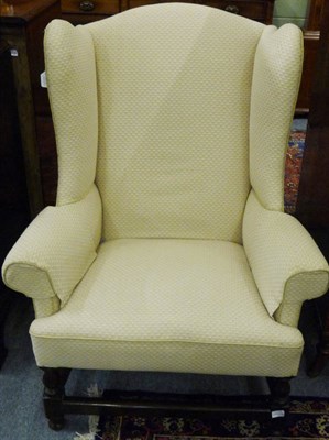 Lot 1510 - A George III Wing Back Chair, upholstered in cream and orange damask, the rounded back support with