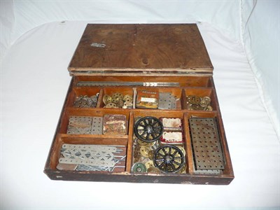 Lot 71 - A Wooden Box Containing Early Nickel Silver Meccano Parts, plus cogs, wheels etc