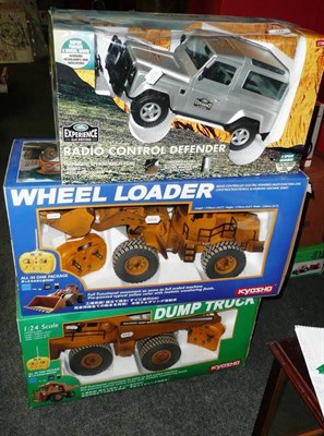 Lot 122 - Three Boxed Large Scale Remote Control Vehicles - Land Rover Defender, Kyosho Dump Truck and Kyosho