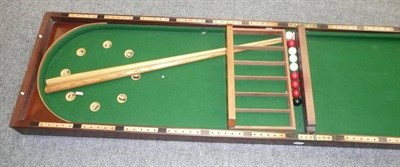 Lot 150 - A Large Folding Mahogany Bagatelle Game, with balls, cues and bone markers