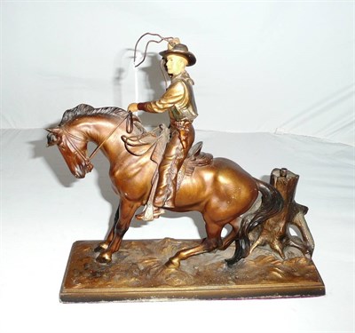 Lot 247 - A Cold Painted Spelter Mounted Cowboy Strike-Lite Petrol Table Lighter, the cowboy with a lasso...