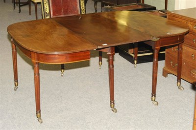 Lot 1533 - A George III Mahogany Dining Table, comprising two conforming D ends with a reeded edge and...