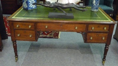 Lot 1535 - A George IV Mahogany Writing Table, the rectangular top with moulded edge and inset green and...