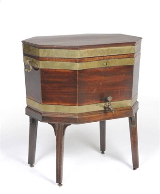 Lot 1539 - A George III Mahogany and Brass Bound Wine Cooler, the octagonal shaped lid opening to reveal a...