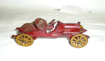 Lot 130 - An American Cast Iron Boat Tailed Roadster, the two piece mould painted red with yellow painted...