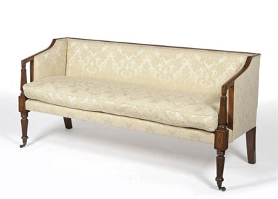 Lot 1548 - A Regency Mahogany Framed Settee, upholstered in cream floral damask, the padded downswept arms...