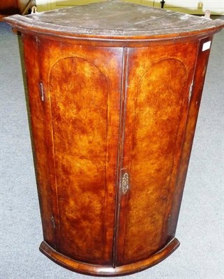 Lot 1550 - A George II Walnut Hanging Corner Cupboard, the bold cornice above two herringbone inlaid...