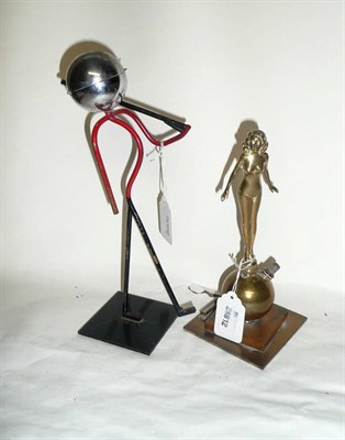 Lot 216 - A Brass Strike-Lite Table Lighter in the Form of a Naked Girl Standing on a Ball, height 20cm;...