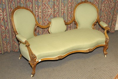 Lot 1561 - A Victorian Walnut Framed Double Chair Back Settee, upholstered in green dralon, the low centre...