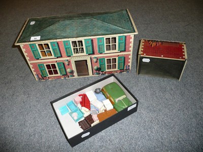 Lot 96 - A Mettoy Lithographed Tinplate Dolls House and Garage, the two storey house with brick effect...