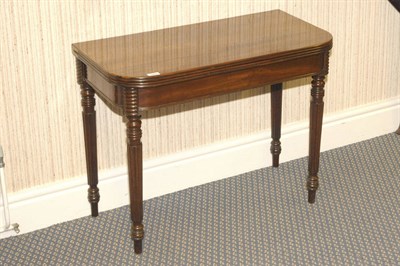 Lot 1569 - A Mahogany Foldover Tea Table, circa 1830, the rounded rectangular top with reeded edge above a...