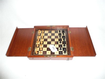 Lot 152 - A Victorian Travelling Chess Set, with boxwood and ebony playing pieces in a folding mahogany case.