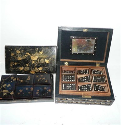 Lot 156 - A 19th Century Black Lacquered Games Box, with gilt decoration, internally fitted with five smaller