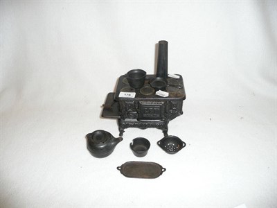 Lot 176 - A Victorian Miniature Cast Iron Stove 'Gem', patented Oct 16th 1894, cast with foliate and fan...