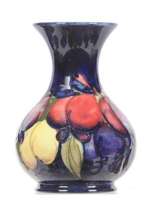 Lot 1585 - A William Moorcroft "Wisteria" Vase, on a blue ground, impressed factory marks and painted blue...