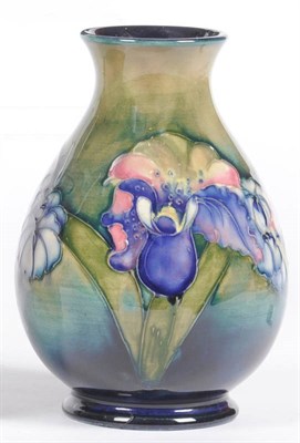 Lot 1587 - A Walter Moorcroft "Orchid and Spring Flowers" Vase, on a green/blue ground, impressed factory...