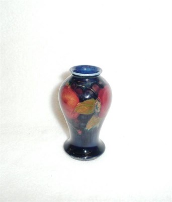 Lot 1589 - A William Moorcroft "Pomegranate" Baluster Vase, on a blue ground, impressed factory marks and...