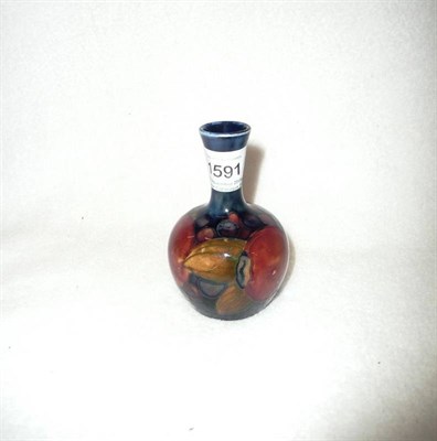 Lot 1591 - A William Moorcroft "Pomegranate" Vase, on a blue ground, impressed factory marks, 9.5cm