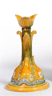 Lot 1598 - A Linthorpe Pottery Candlestick, shape No.2177, moulded with three fish heads and green scales,...