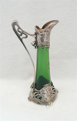 Lot 1617 - An Art Nouveau WMF Claret Jug, No.190k, green glass body, mounted with a pierced stylised frame...