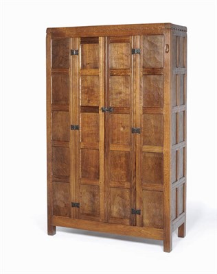 Lot 1630 - A Robert "Mouseman" Thompson Oak Panelled Hall Wardrobe, 1931, with castellated top, adzed all...