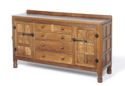 Lot 1633 - A Robert "Mouseman" Thompson Oak Panelled Sideboard, 1937, with raised upstand, adzed all over,...