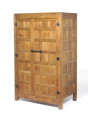 Lot 1634 - A Robert "Mouseman" Thompson Oak Panelled Wardrobe, dated 1935, castellated top above two doors...