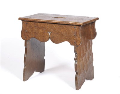 Lot 1646 - A Robert "Mouseman" Thompson Oak Boarded Stool, made of five shaped boards held together with...