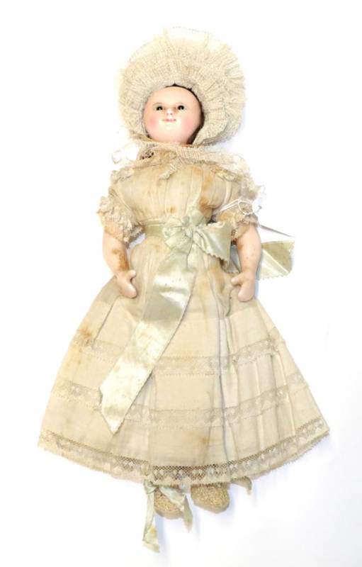 Lot 2000 - A 19th Century Wax Shoulder Head Doll, with oval black eyes, original brown wig, pink cheeks...